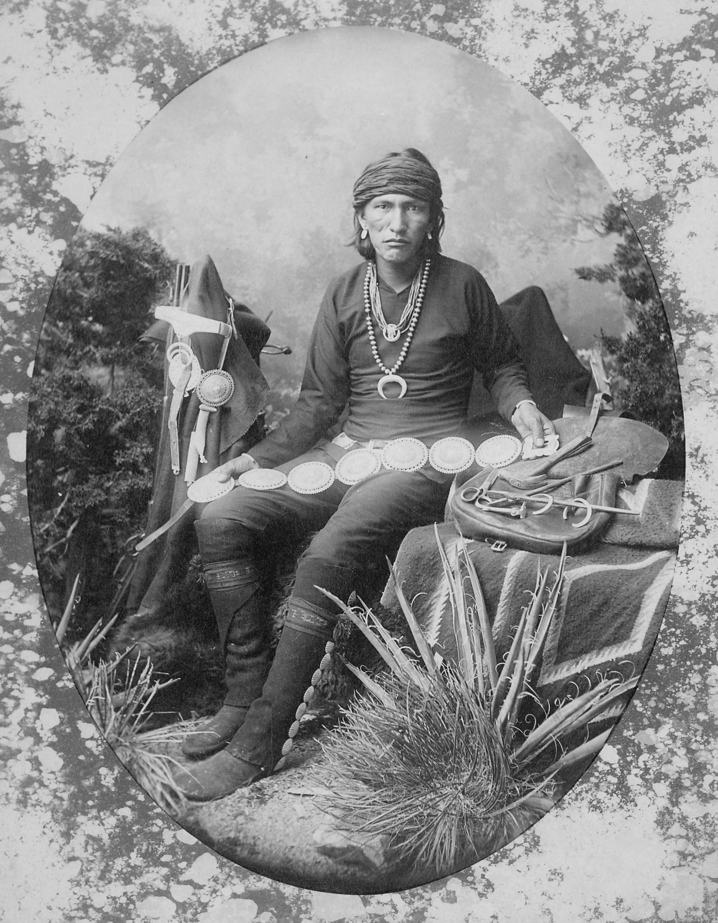 Navajo silversmith with examples of his work and tools, 1880 - NARA - 518913
