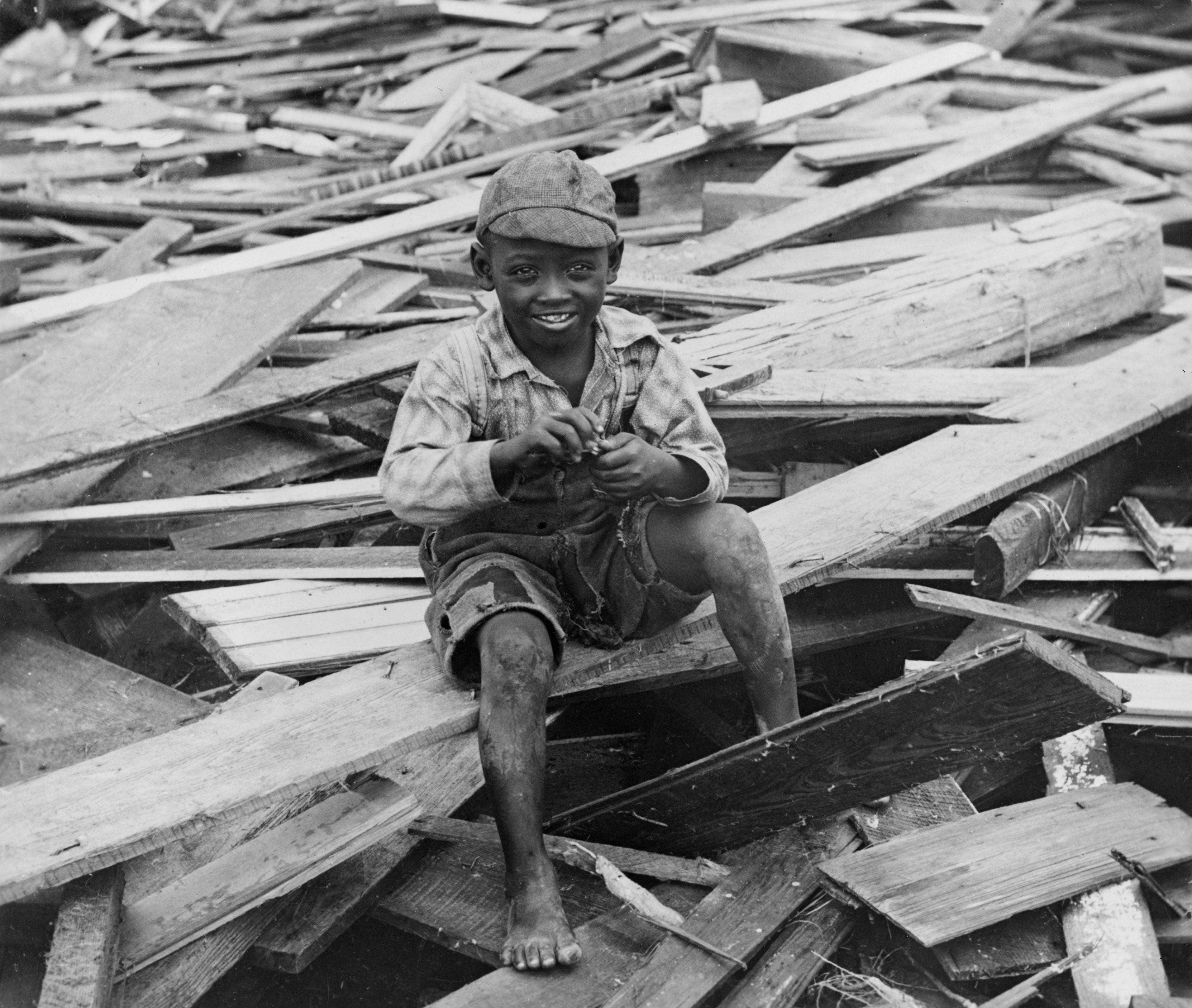 No Known Restrictions Young Boy Sits on Galveston Hurricane Debris by M.H. Zahner, 1900 (LOC) (493281477)