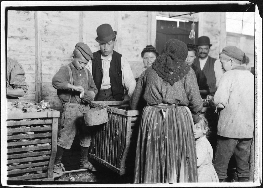 9 year old Johnnie and the shucking boss. He is also a padrone. For four years he has brought these people from... - NARA - 523419