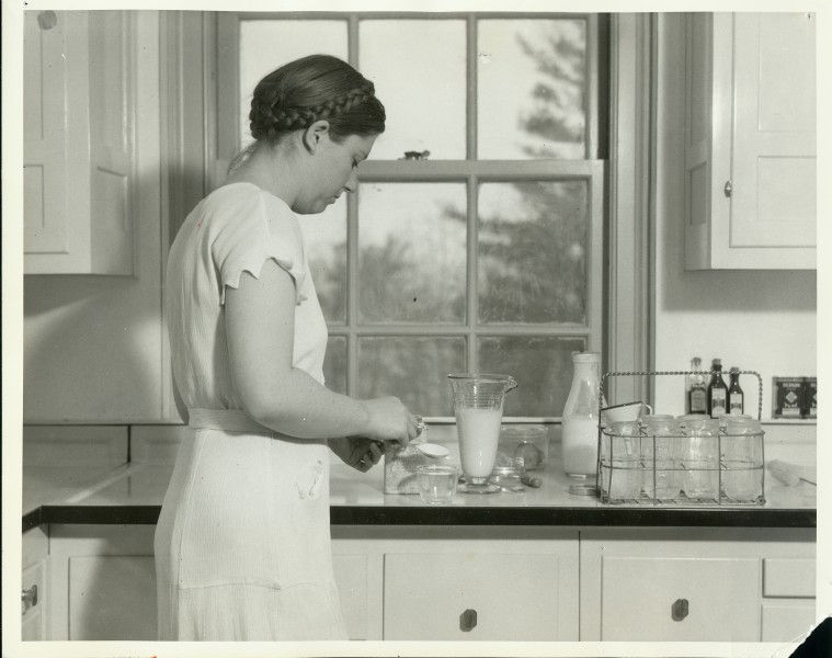 A student 'mother-of-that-week' living in one of the homemaking apartments prepares the day's food - (3857207084)