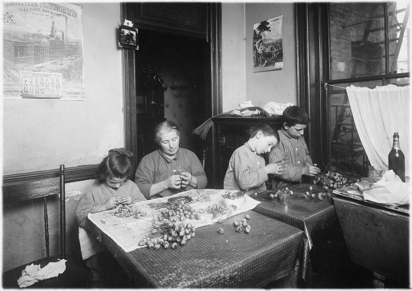 Basso family, making roses in dirty poorly lighted kitchen. Pauline, 6 years old, works after school. Peter, 8, works... - NARA - 523515