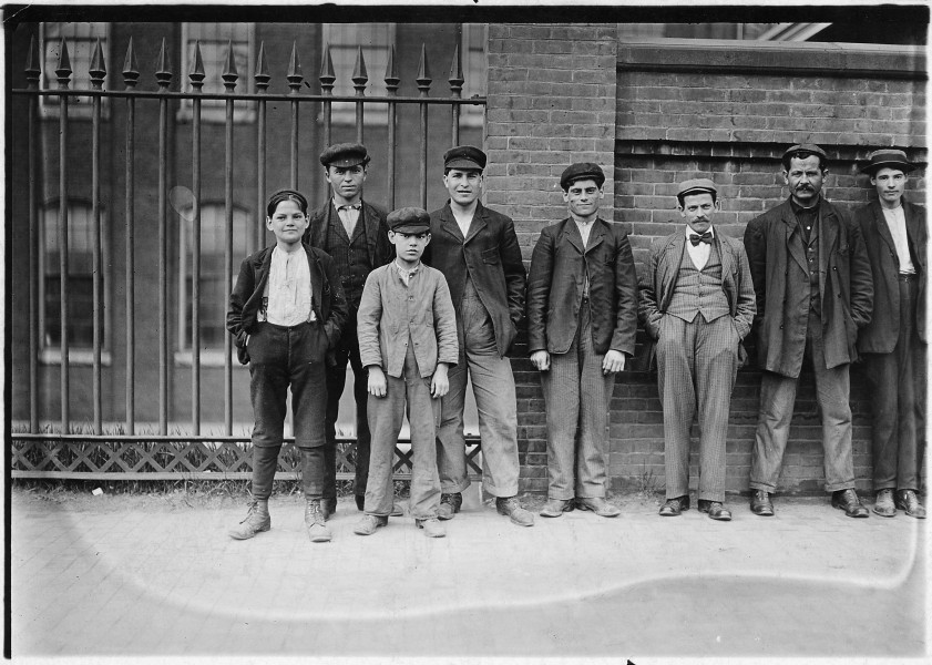 Boy on left hand end (hands in pocket) is Peter Carlos, been working in mill for 1 1-2 years. Smallest boy is... - NARA - 523197