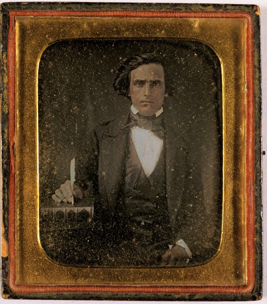 Daguerreotype. Portrait of a man with a book and pen.