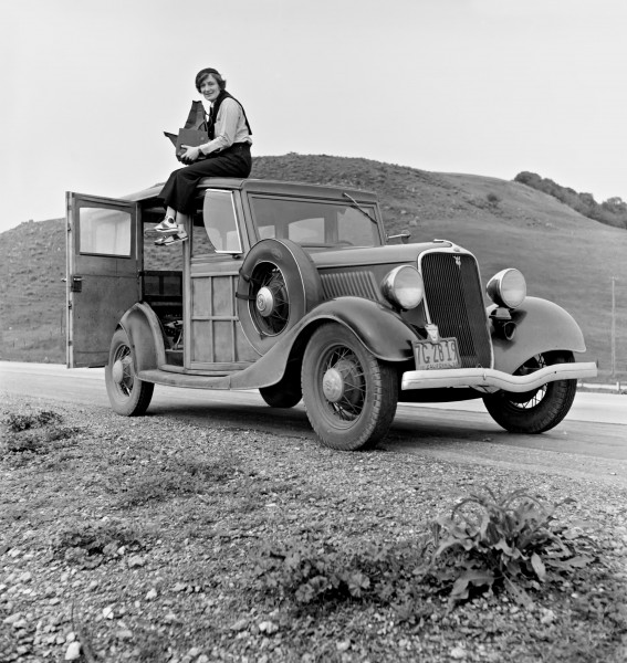 Dorothea Lange atop automobile in California