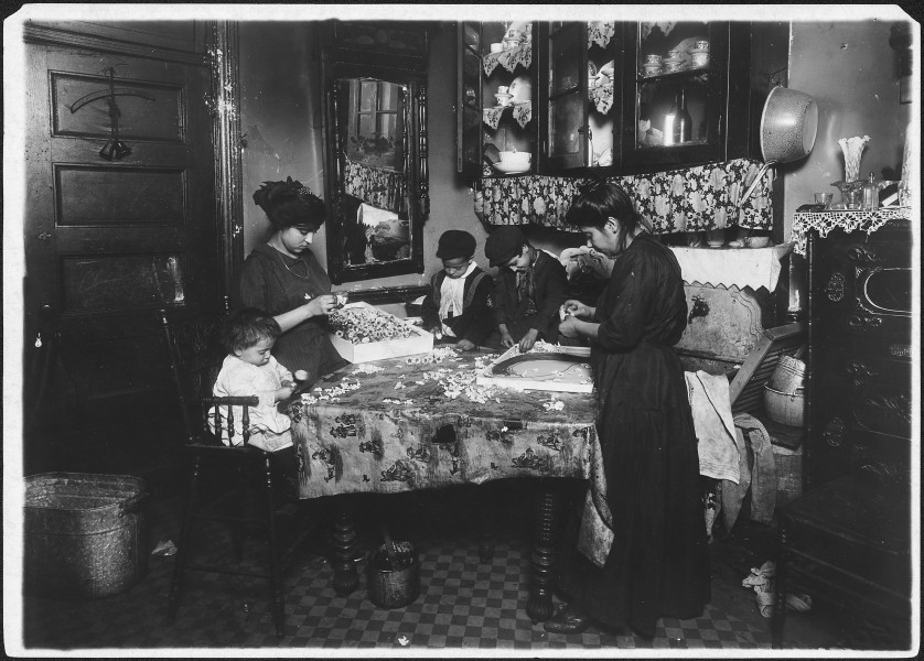 Family of Mrs. Motto making flowers in a dirty tenement. Josephine, 13 years, helps outside of school hours until 9... - NARA - 523495