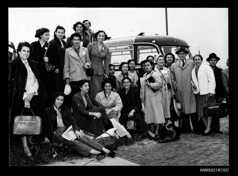 Group of young women standing hear a bus, apparently before migrating to Australia (8403972132)
