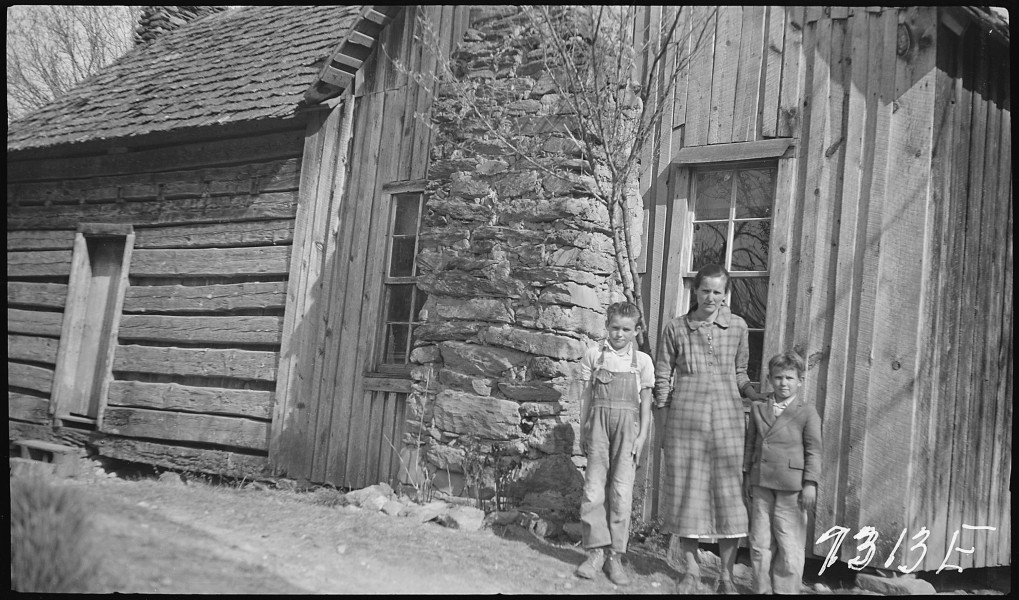 Hogshed, P.C., wife and children in front of home - NARA - 280789