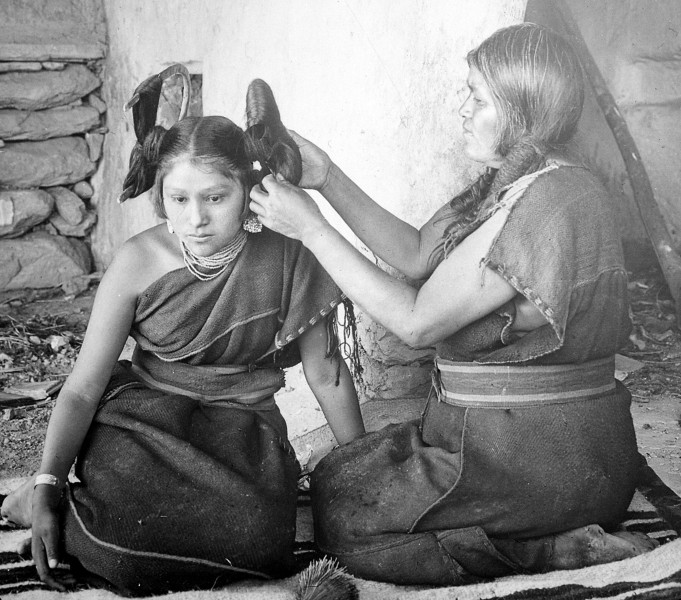 Hopi woman dressing hair of unmarried girl