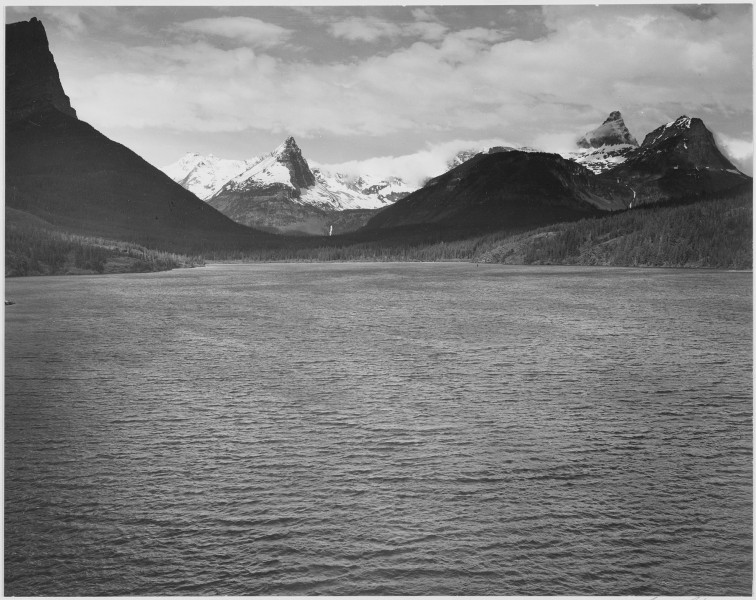 Looking across toward snow-capped mountains, lake in foreground, 