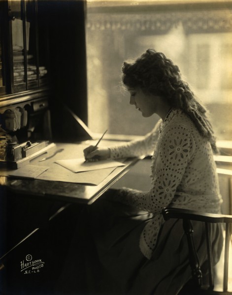 Mary Pickford writing at a desk