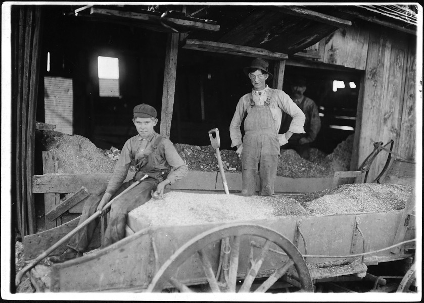 No caption. Young boy and two men gathering ore - NARA - 523334