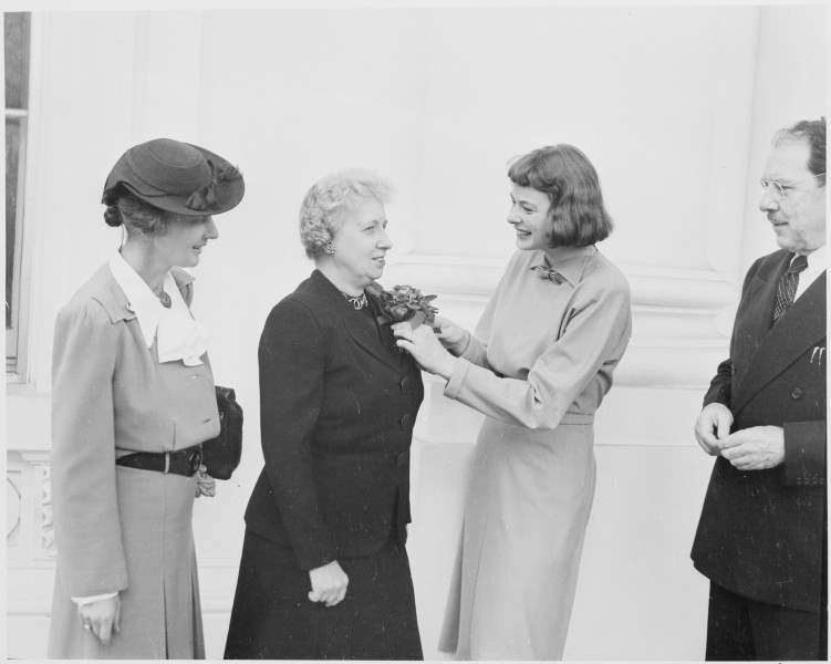 Photograph of actress Ingrid Bergman pinning a corsage on First Lady Bess Truman, who received a community chest... - NARA - 199441