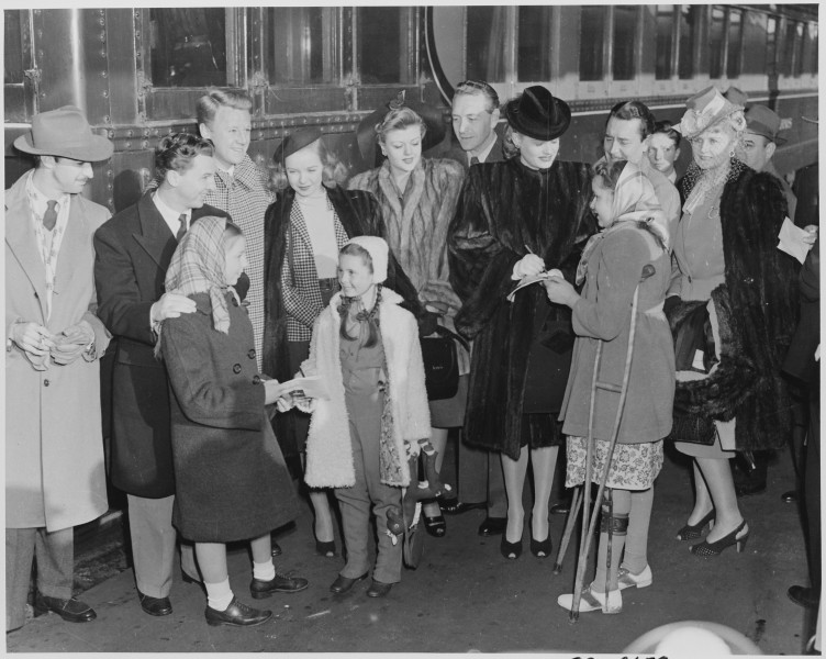 Photograph of movie stars signing autographs upon their arrival in Washington to participate in Roosevelt Birthday... - NARA - 199314