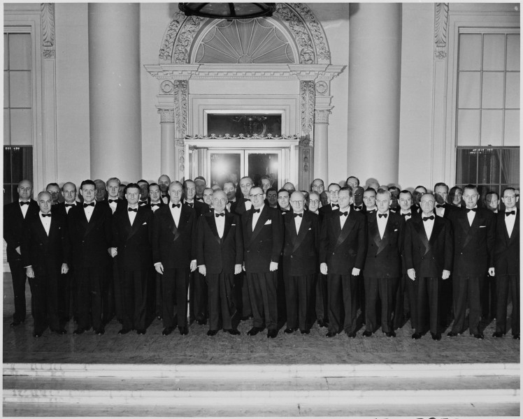Photograph of President Truman outside the White House with his 
