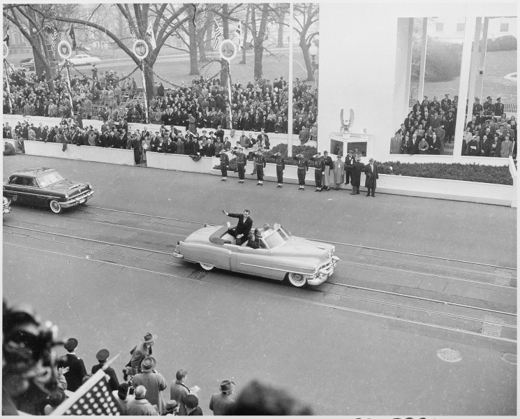 Photograph of Vice President Richard M. Nixon waving to crowds as he rides in the Inaugural parade. - NARA - 200424