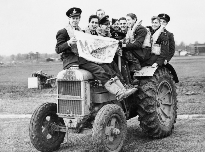 Pilots of No. 601 Squadron RAF use a tractor to negotiate muddy conditions on their airfield at Exeter, November 1940. CH17324
