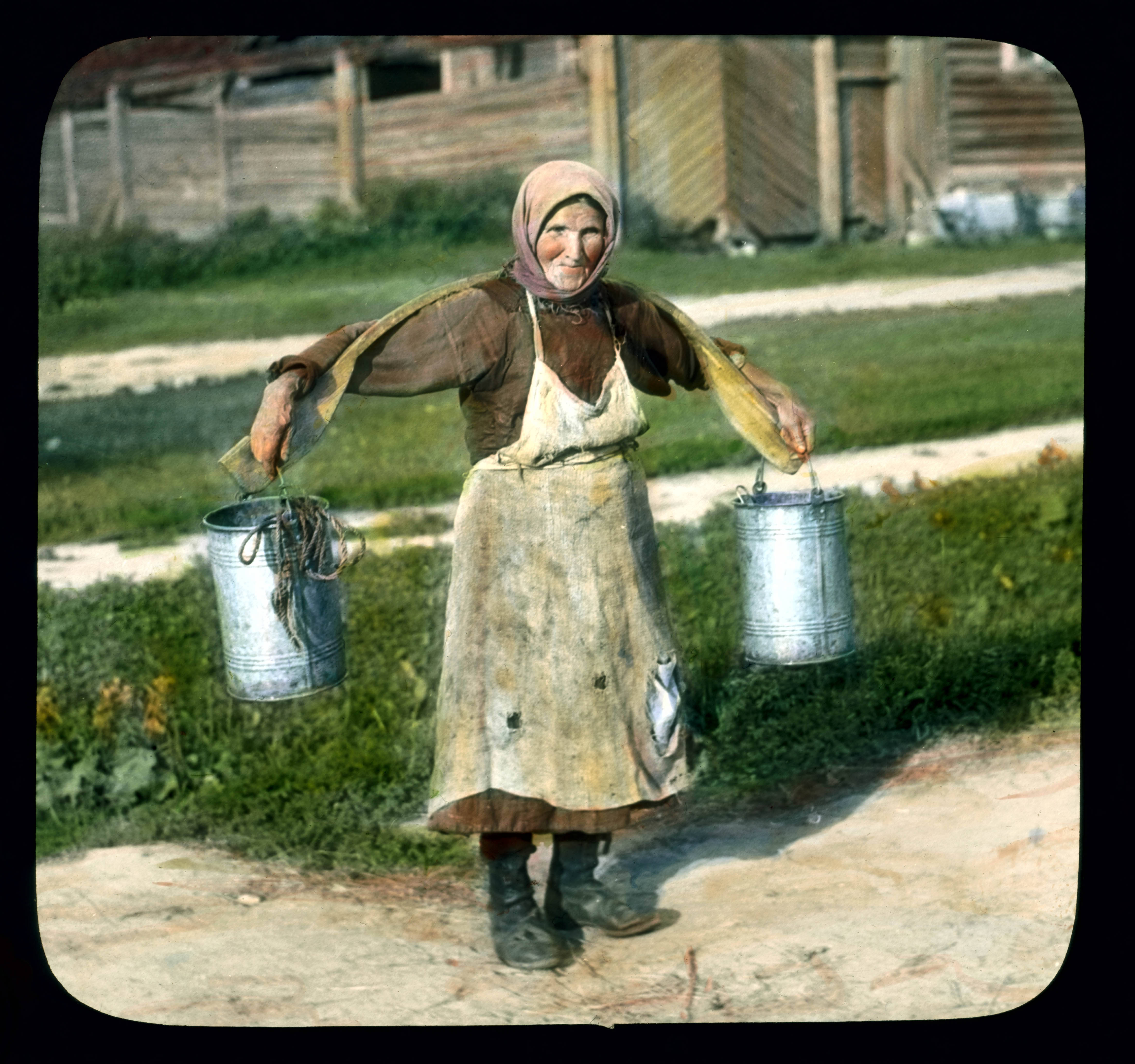 Saint Petersburg woman carrying buckets of water, near Leningrad