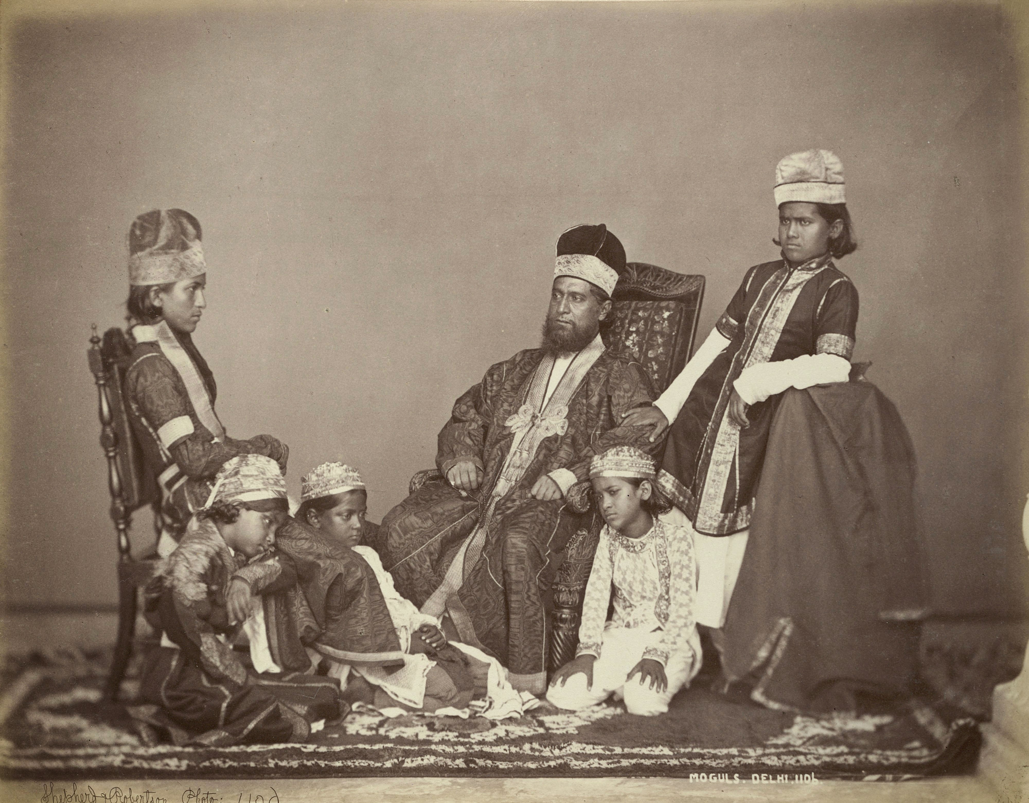 Studio portrait of a Mogul father with his children at Delhi, by Shepherd and Robertson