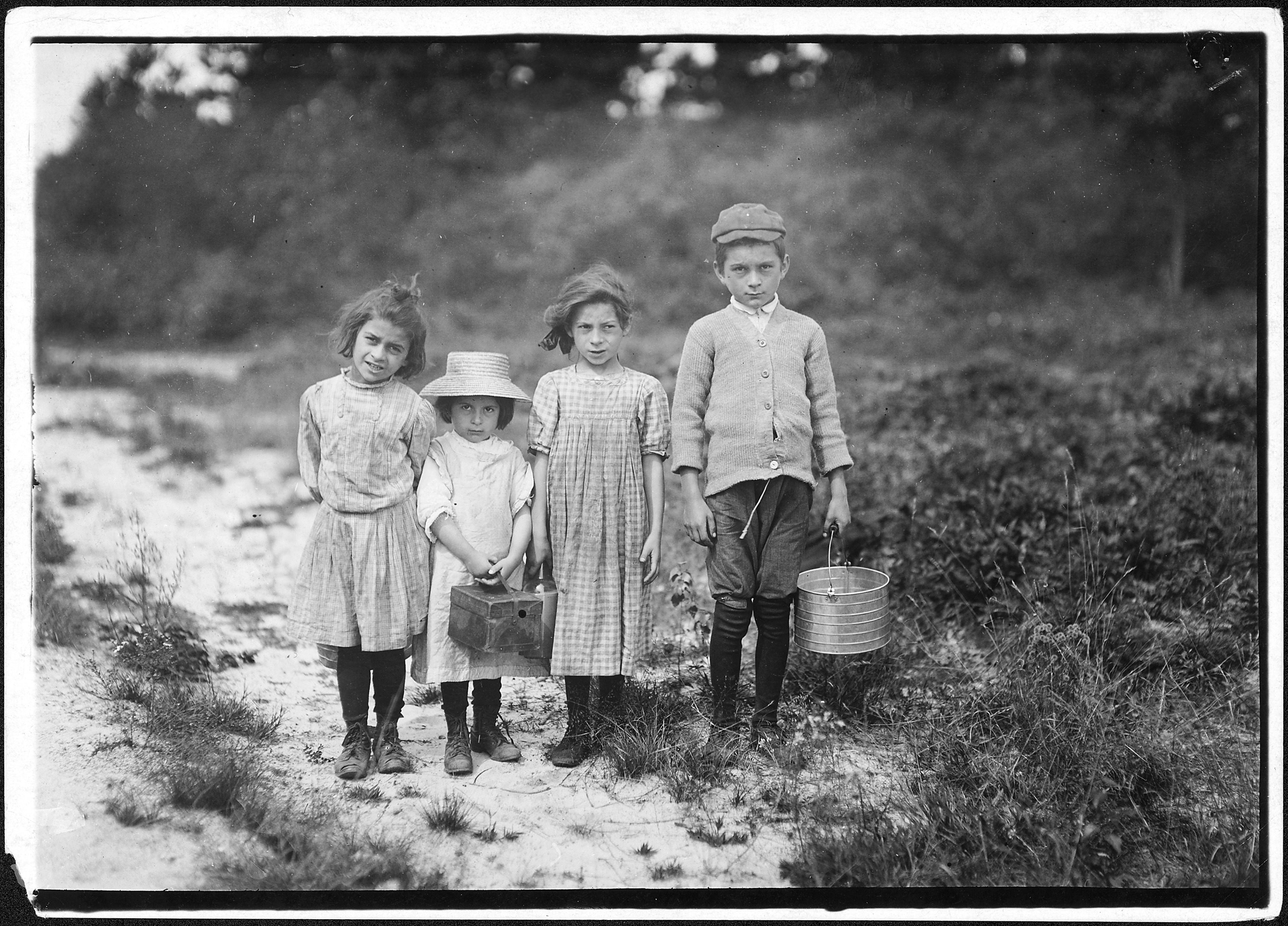 Three pickers going home from work. Anne, 7 years old, and brother Vincent said 11. Vincent picked last summer. Inez... - NARA - 523465