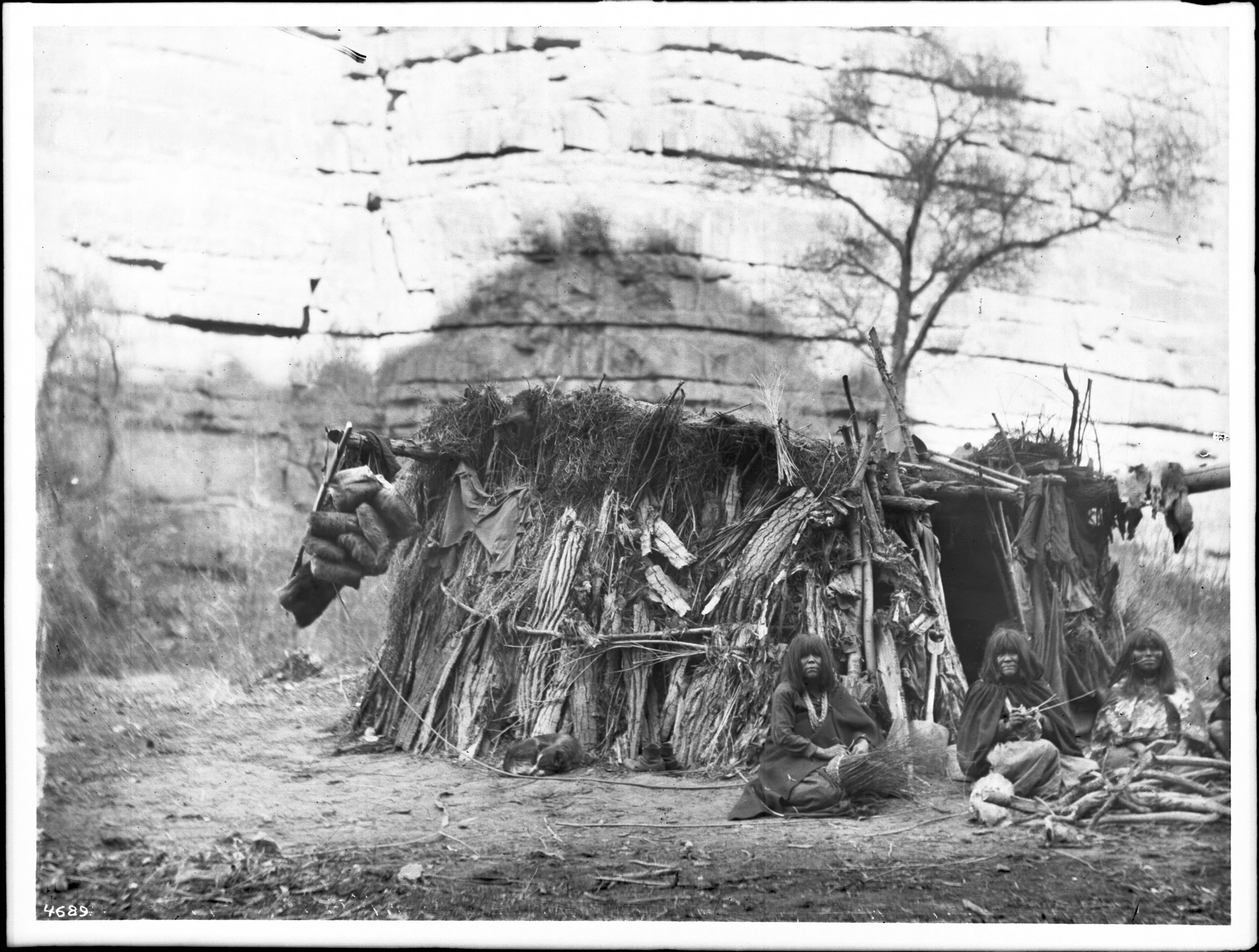 Havasupai women making baskets in front of a dwelling in Havasu or Cataract Canyon, ca.1900 (CHS-4689)