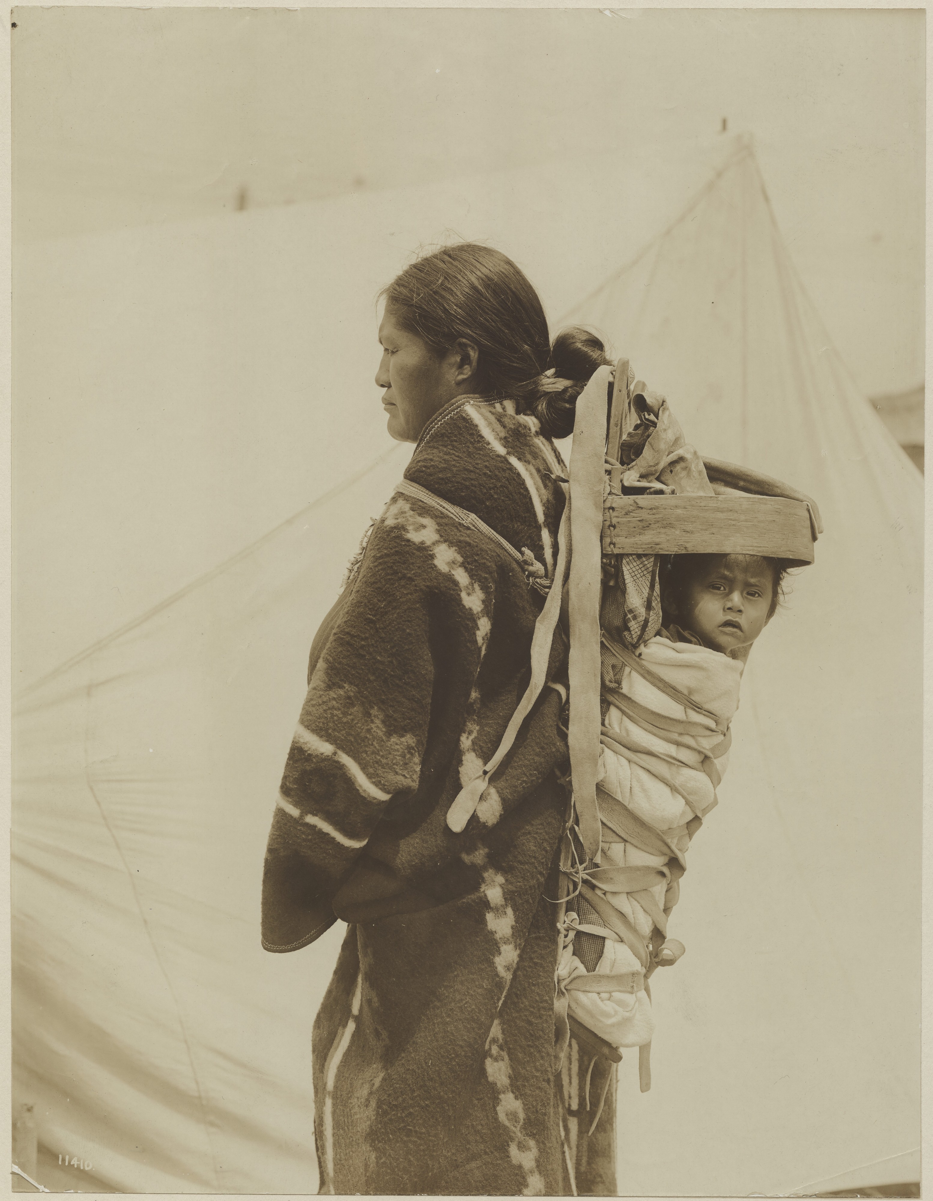 Navajo American Indian woman carrying her child in a cradleboard on her back in the Department of Anthropology exhibit at the 1904 World's Fair