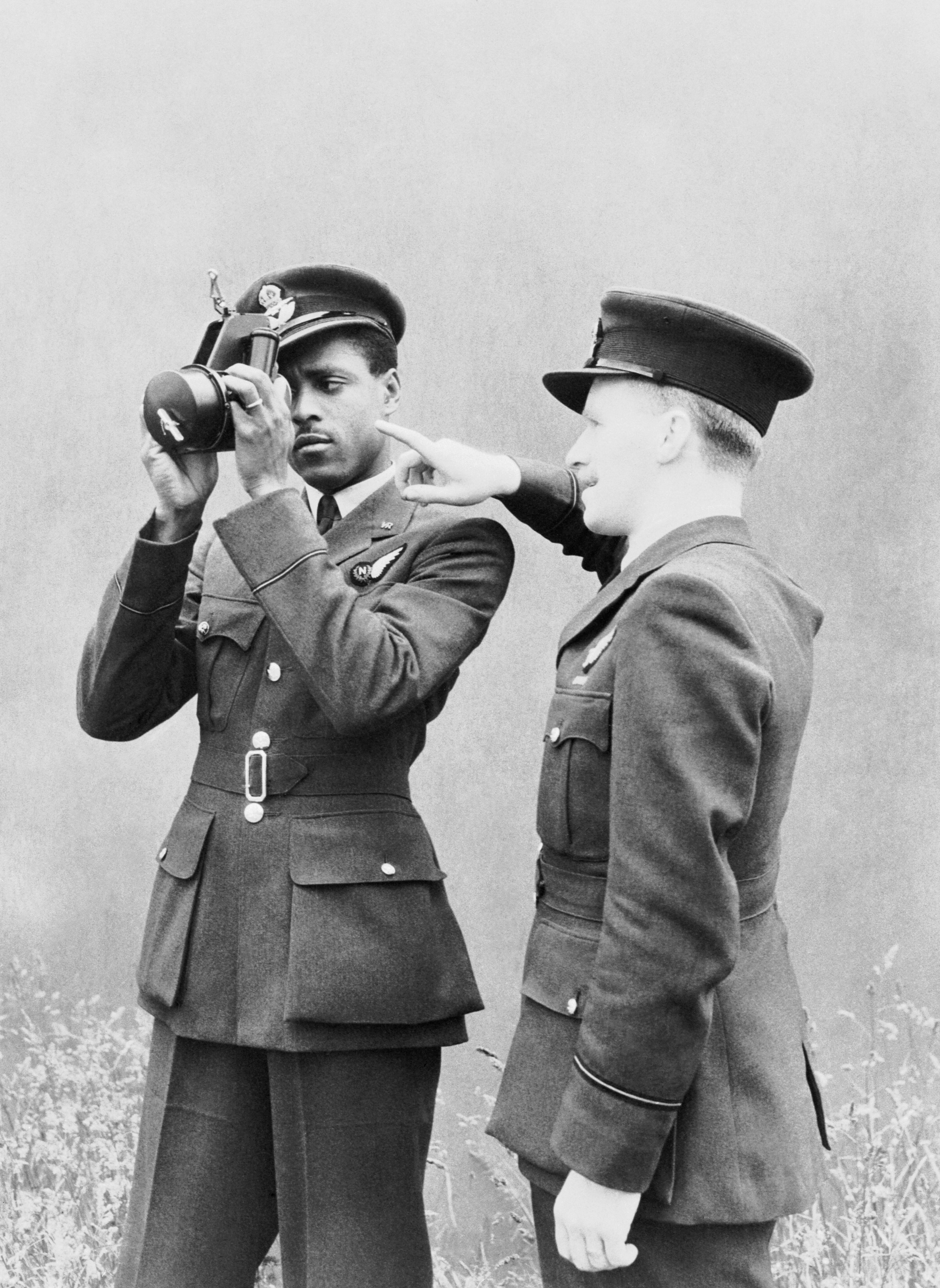 Pilot Officer J H Smythe of Sierra Leone, a newly-qualified navigator, being instructed in the use of the sextant by an instructor at No. 11 Operational Training Unit, Westcott in Buckinghamshire, 1 August 1943. CH10740