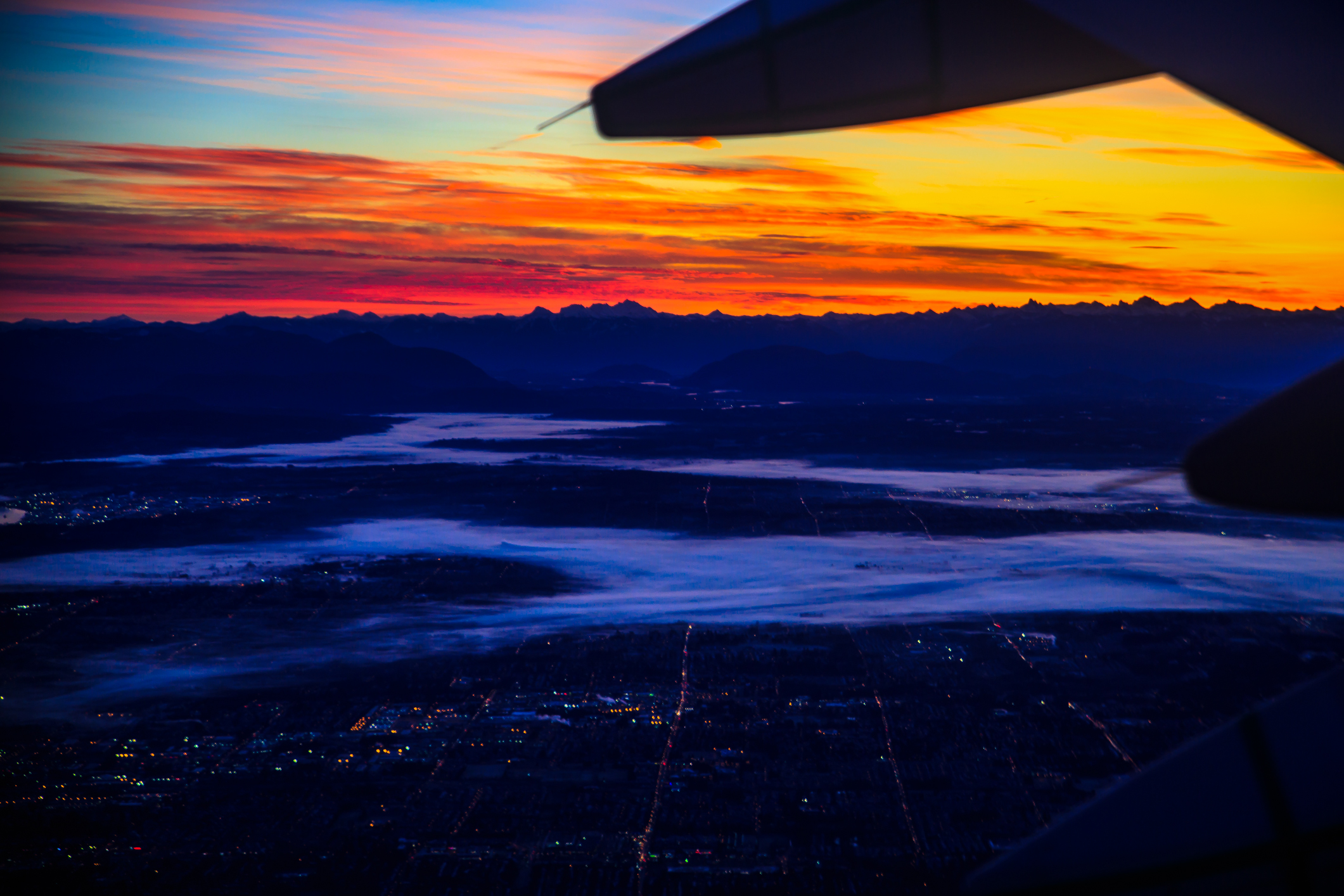 Sunrise over the lower Fraser valley after take off from Vancouver (12259561155)