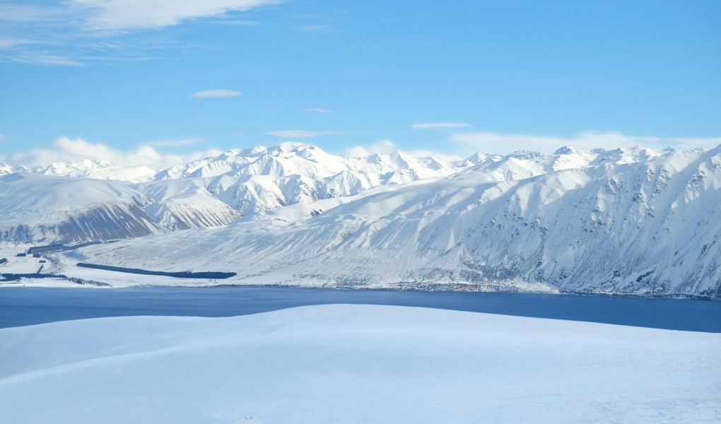 View over northern part of Lake Tekapo and snow-covered mountains