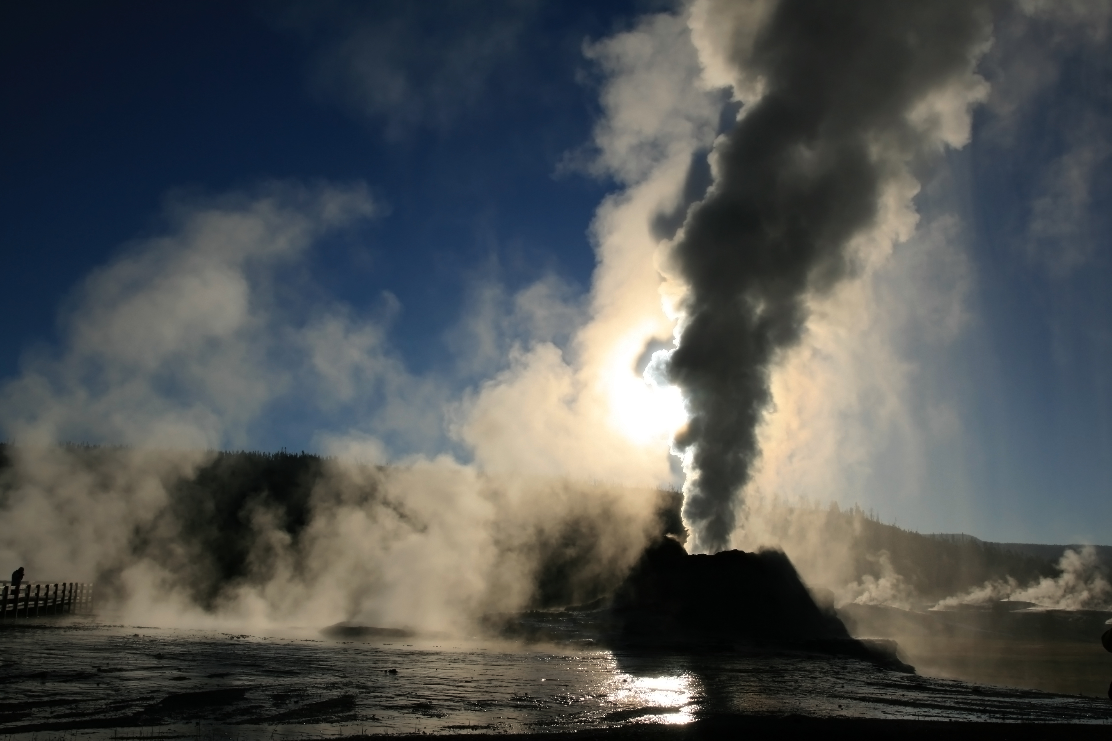 Steam Phase eruption of Castle geyser with shadows