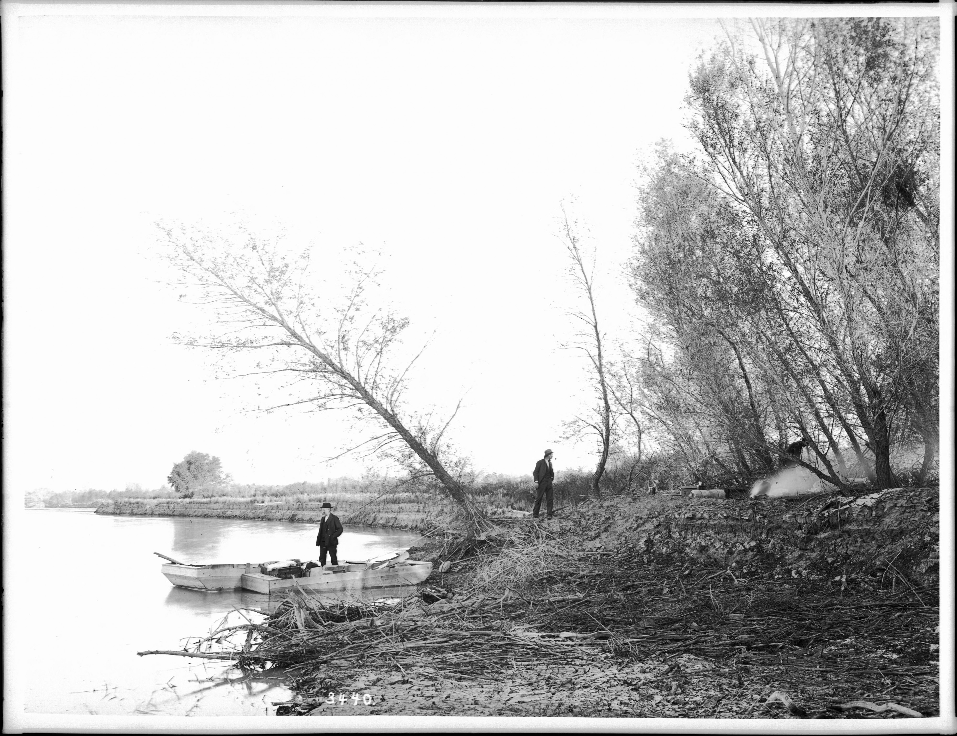 Small outboards landing to make camp on the shore of the Colorado River, ca.1900 (CHS-3440)