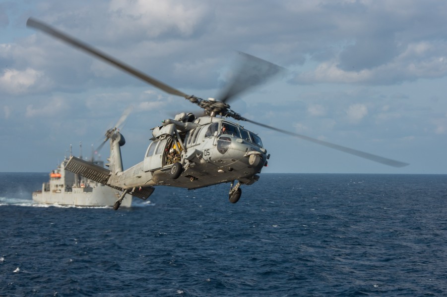 An MH-60S Sea Hawk helicopter assigned to Helicopter Sea Combat Squadron (HSC) 25 returns to the Military Sealift Command dry cargo and ammunition ship USNS Washington Chambers (T-AKE 11)