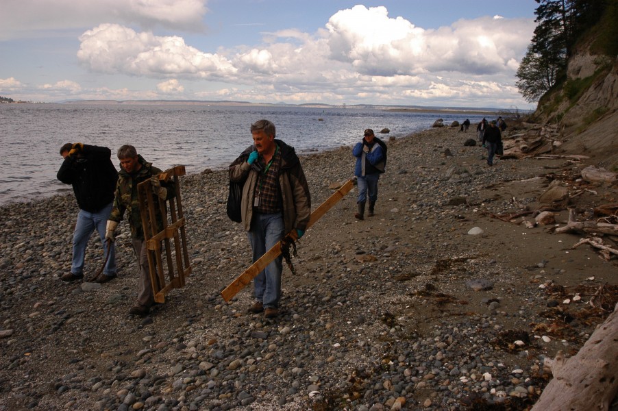 US Navy 100521-N-4386D-002 Department of Defense civilians and military personnel pick up trash and debris on the beach at Naval Magazine Indian Island, Washington