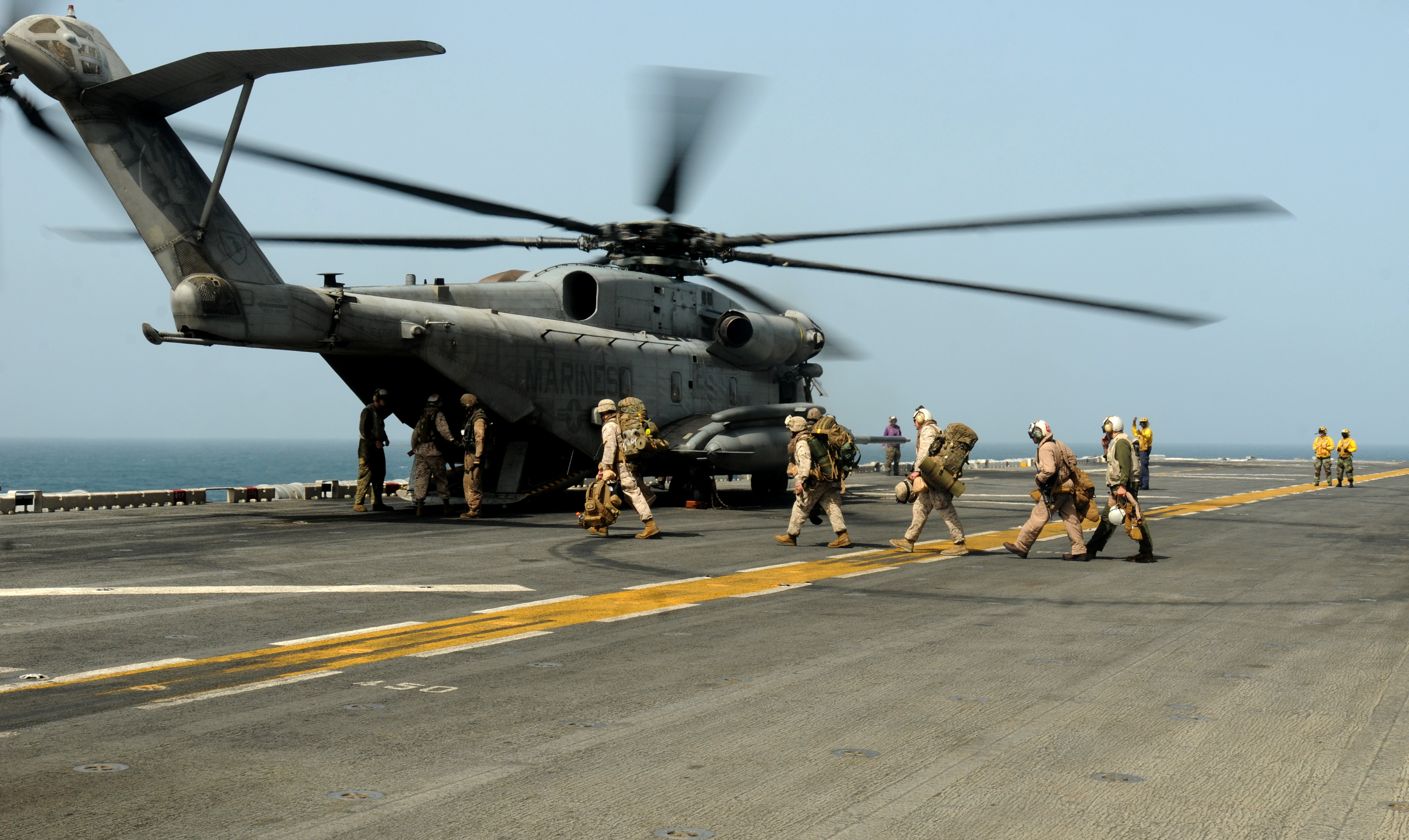 U.S. Marines prepare to board a CH-53E Super Stallion helicopter aboard the USS Peleliu (LHA 5) (100812-N-1226D-050 (4887886289))