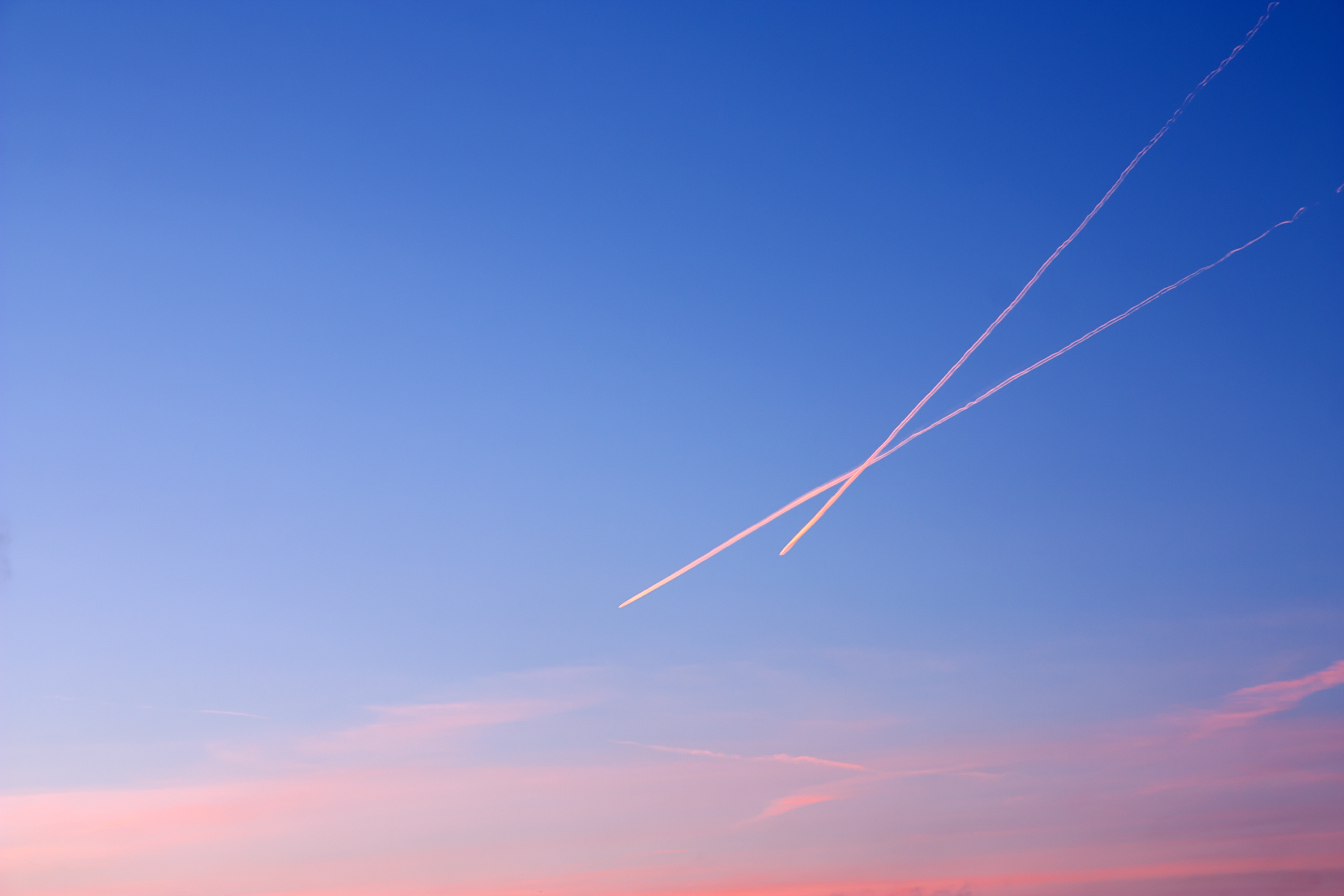 Contrails in the sky at sunset