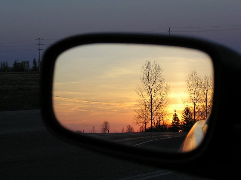 Car side mirror sunset