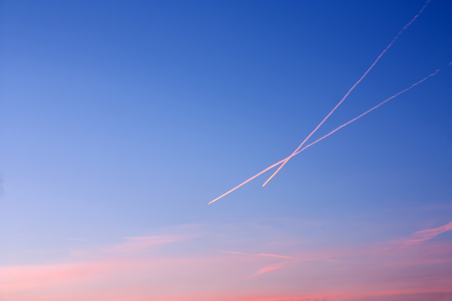 Contrails in the sky at sunset