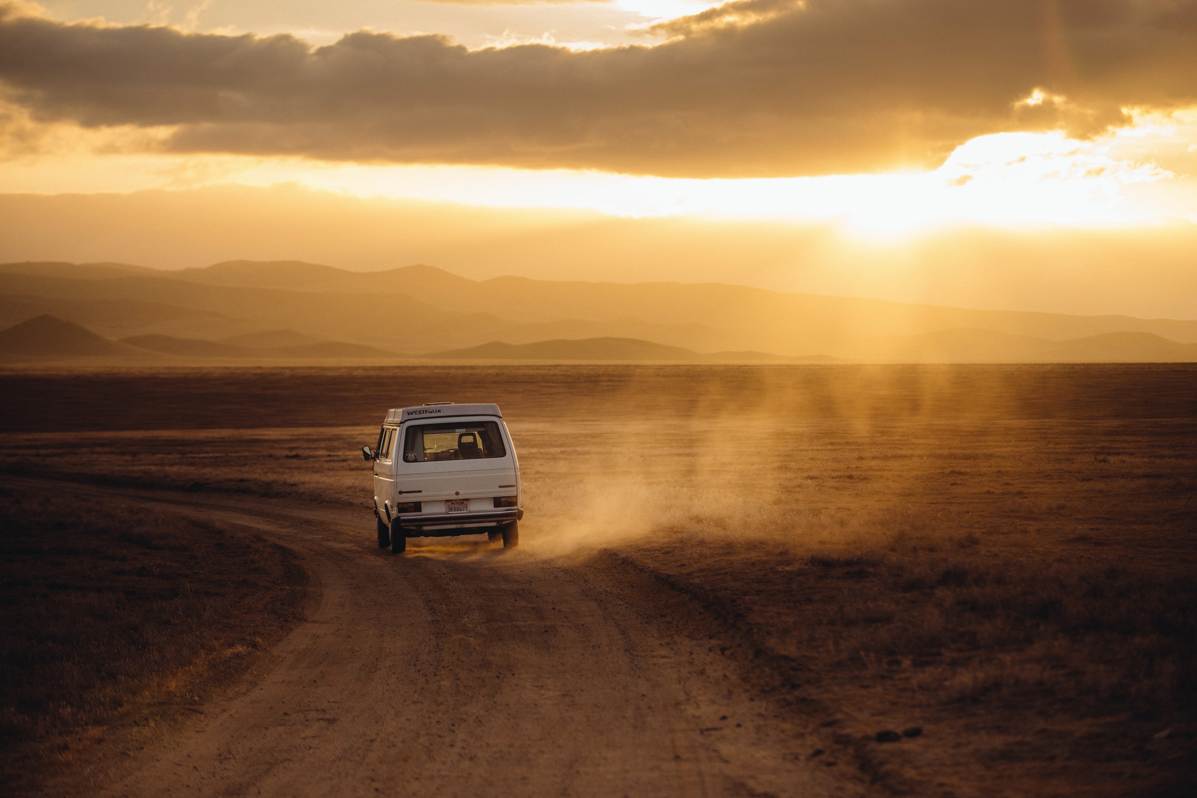 Road dust under setting sun (Unsplash)