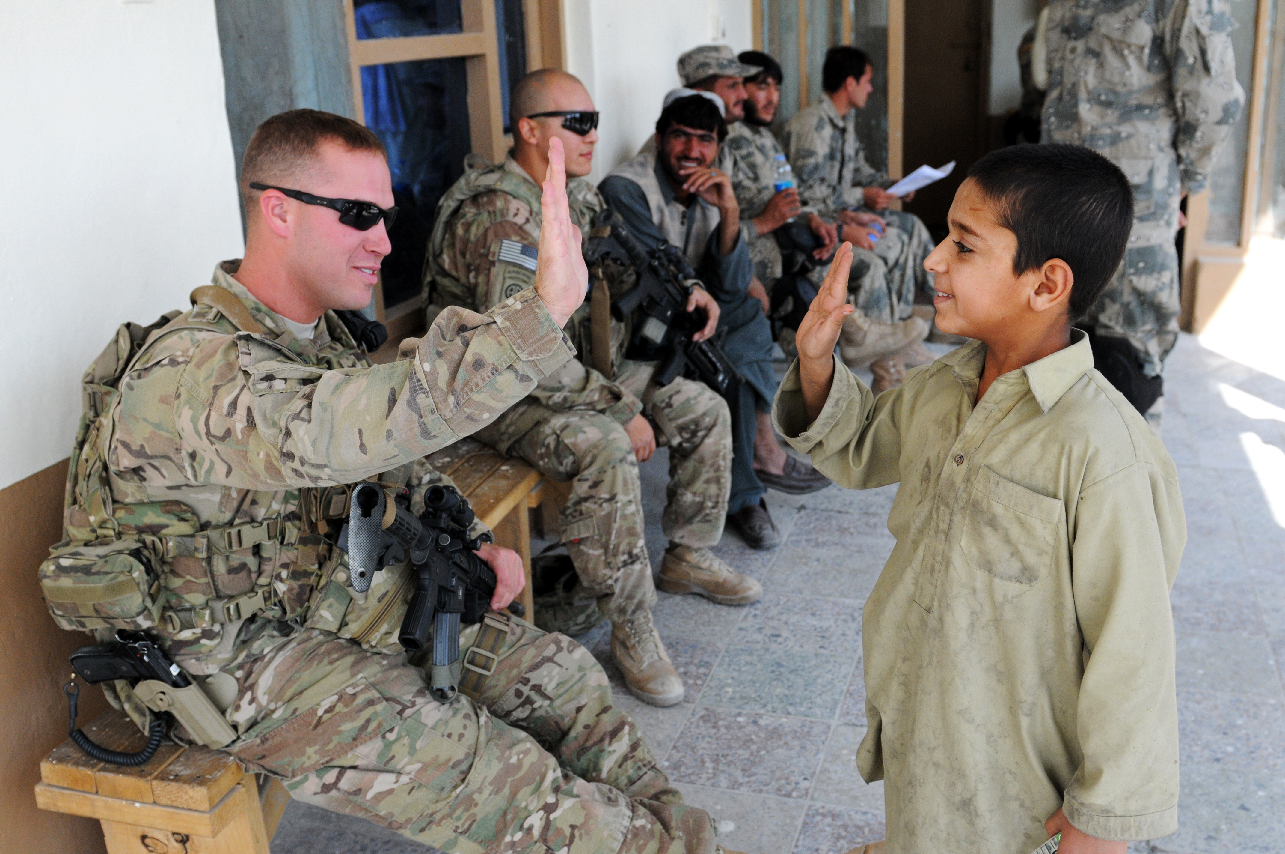 82nd Airborne Division medic high-fives Afghan boy DVIDS483321