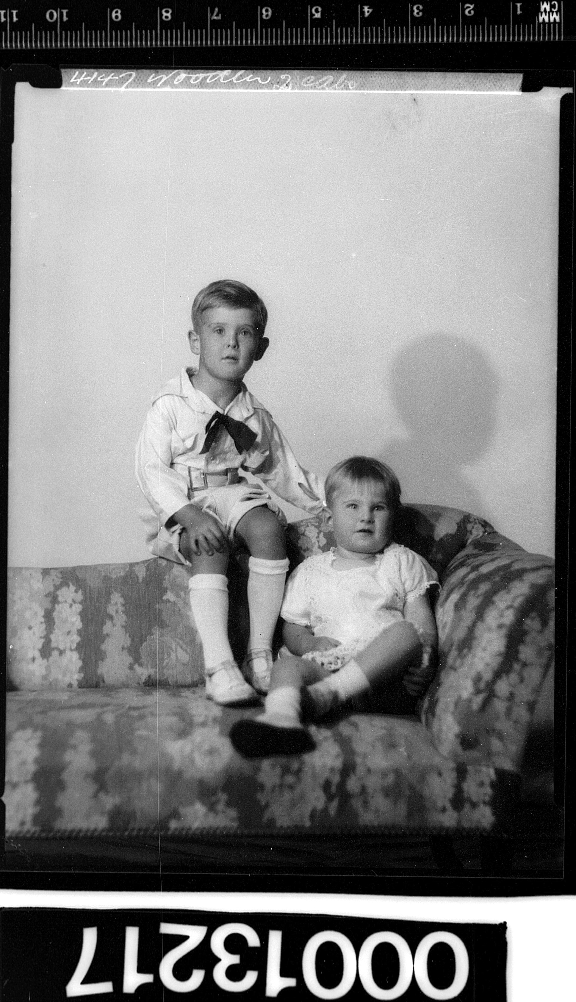 Portrait of two children sitting on a couch (8123577258)