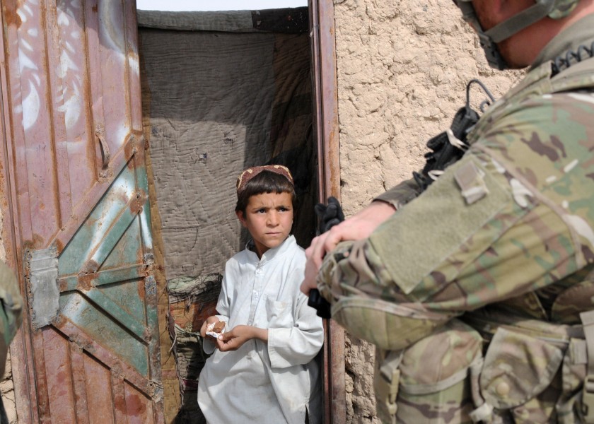 A U.S. Soldier speaks with a child during a foot patrol in the Maiwand district of Kandahar province, Afghanistan, Oct. 21, 2011 111021-A-ON828-002