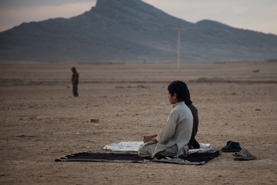 Afghan boys pray outside Combat Outpost Senjaray in Kandahar province, Afghanistan, Jan. 3, 2012 120103-A-VB845-186