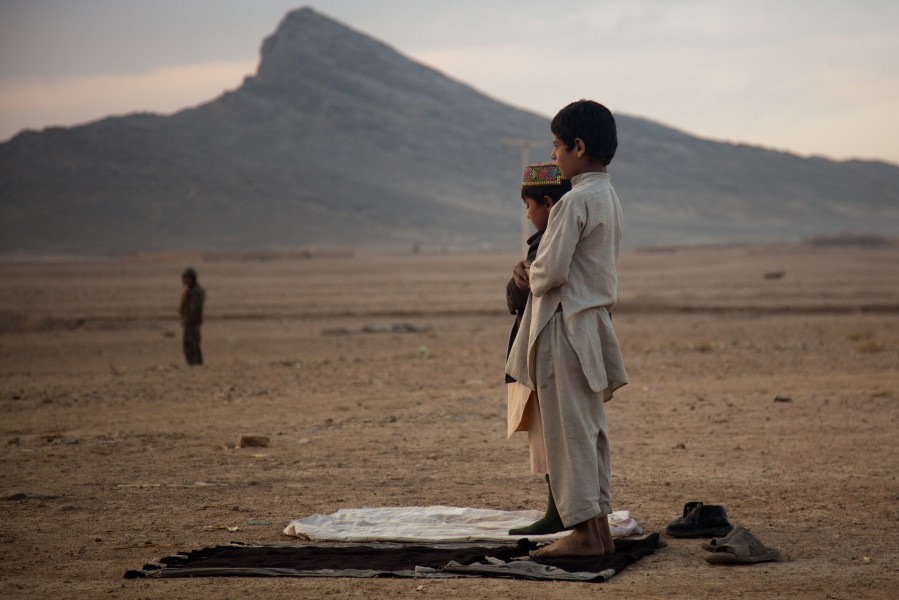 Afghan boys pray outside Combat Outpost Senjaray in Kandahar province, Afghanistan, Jan. 3, 2012 120103-A-VB845-187
