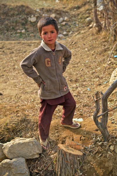 An Afghan boy watches as U.S. Soldiers and Airmen with the Kentucky National Guard Agribusiness Development Team 3 (KY ADT 3), Task Force Hurricane, provide security in Charikar district, Parwan province 120103-A-LP603-047