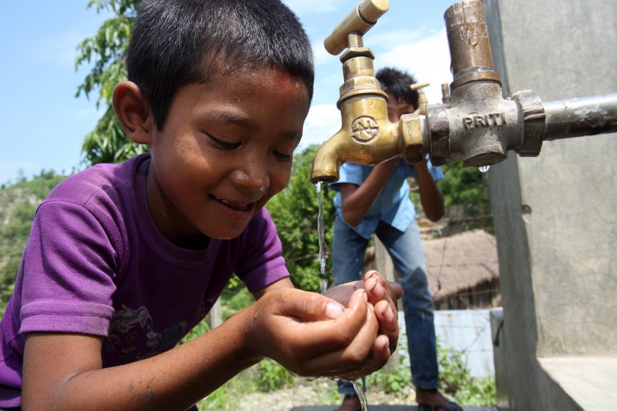 Boy drinks from a tap at a NEWAH WASH water project in Puware Shikhar, Udayapur District, Nepal. (10677936093)