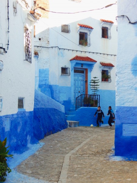 Boys playing soccer on the street in Chefchaouen Morocco