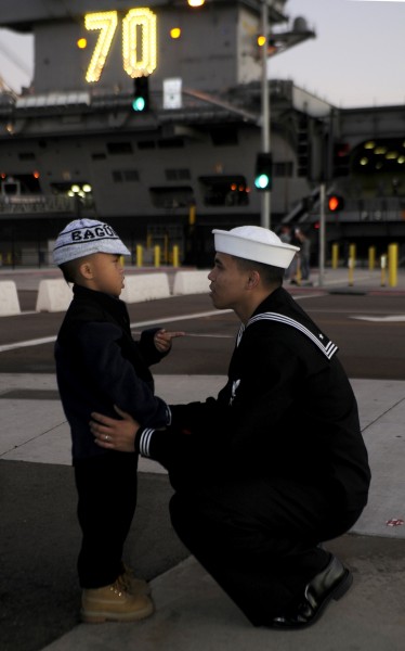 Defense.gov News Photo 111130-N-GZ277-115 - U.S. Navy Petty Officer 3rd Class Teejay Sunglao says goodbye to his son before the aircraft carrier USS Carl Vinson CVN 70 departs Naval Air