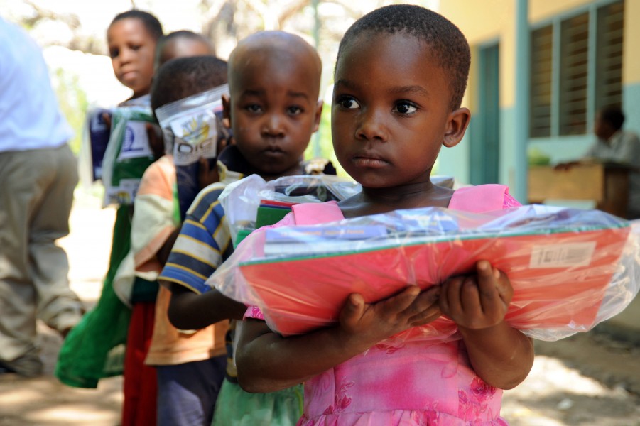 US Navy 091102-N-2420K-127 A child holds a packet of school supplies at the Tongoni Primary School in Tanga, Tanzania