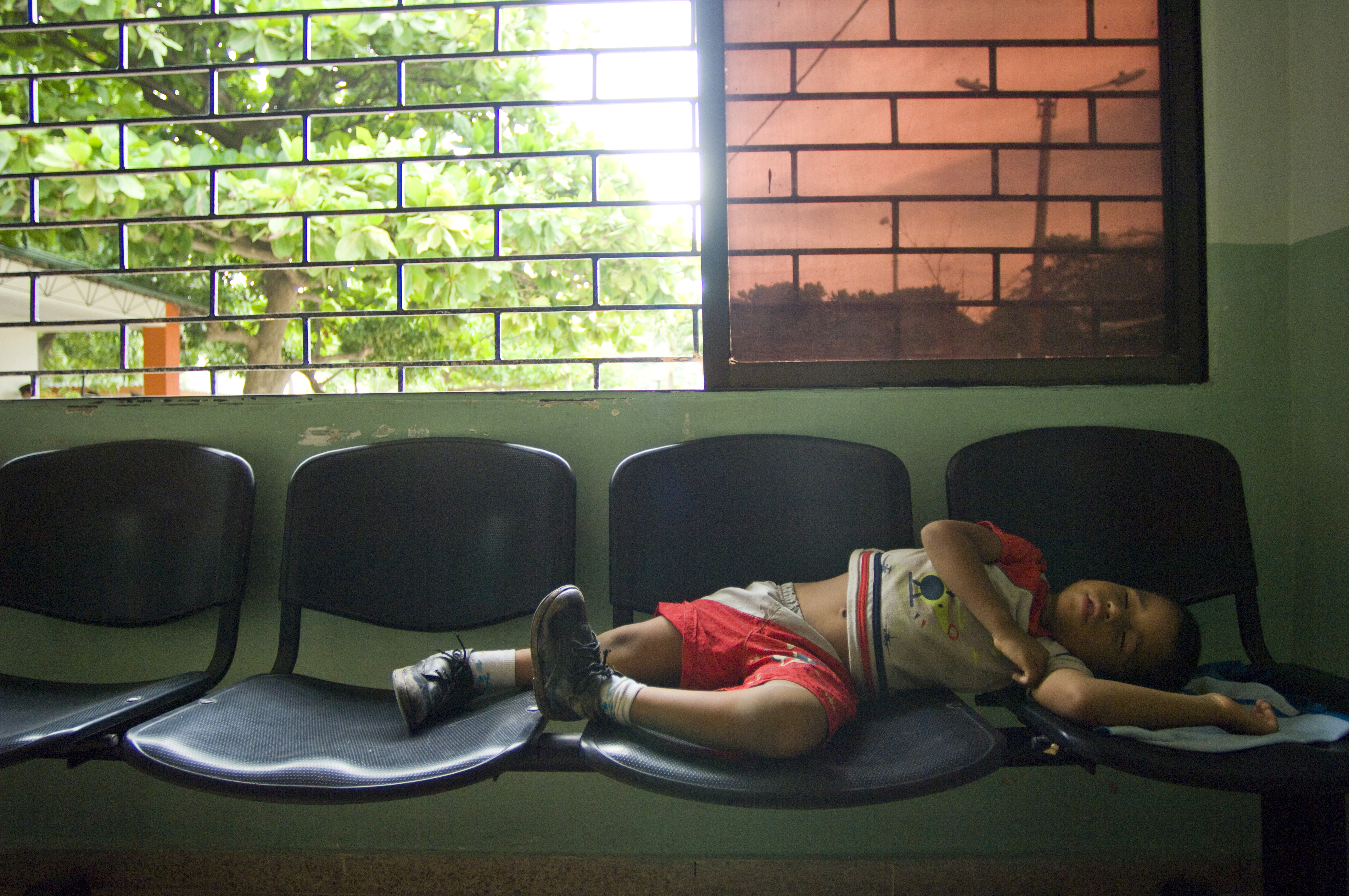 US Navy 080831-N-9620B-284 A local Colombian boy sleeps in a waiting room