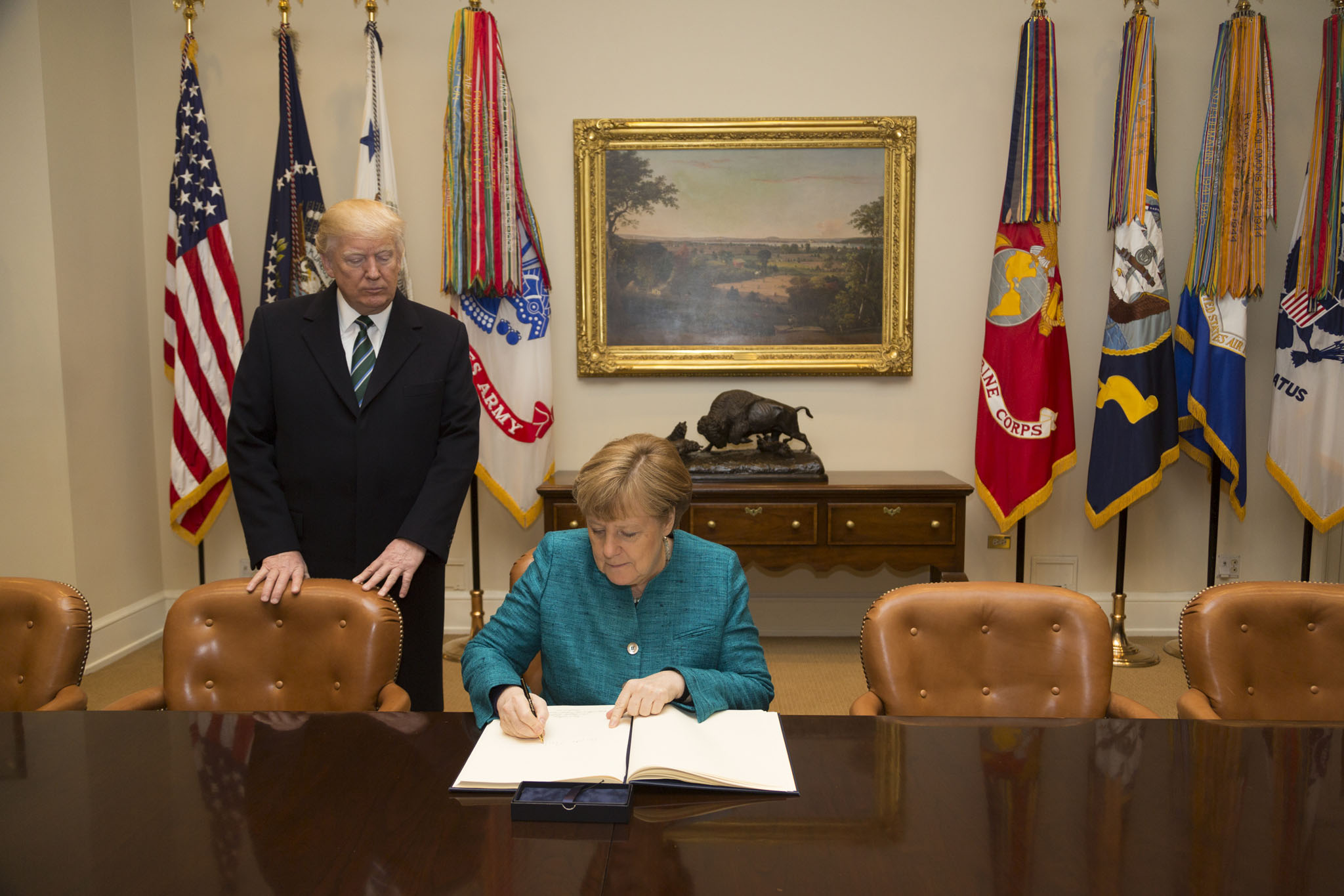 Angela Merkel signs the guest book in the Roosevelt Room, March 2017