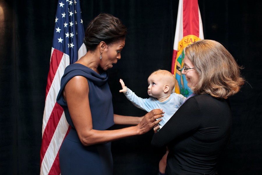 A child reaches out to First Lady Michelle Obama, 2012